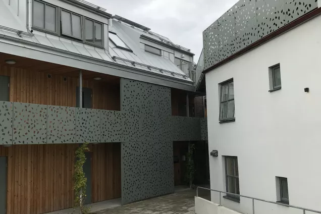 An overview of the outside of the housing area Albogatan showing the grey and white exterior of the building.