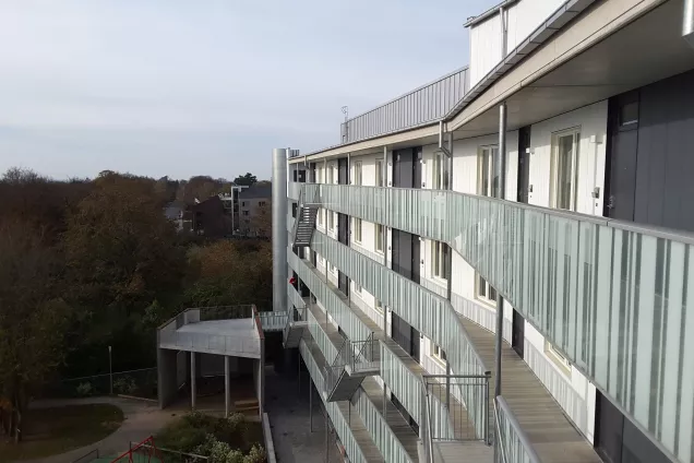 The view from the top floor at the housing area Sofieberg showing the building to the right and the park to the left (picture)